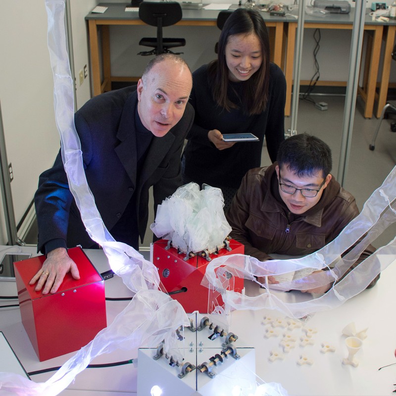 professor and students in a design lab