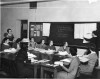 1935 photo of a professor at a blackboard teaching to seated college students