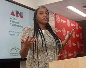 Woman standing at a podium speaking