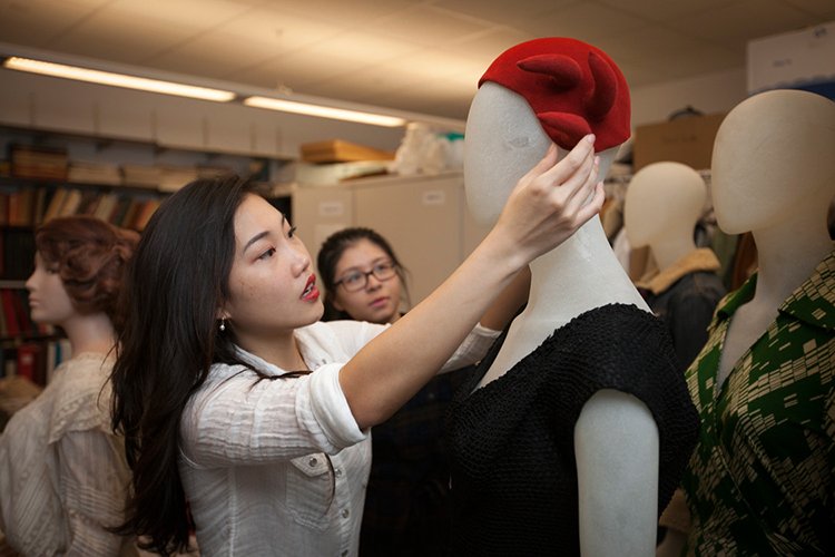 placing hat on mannequin