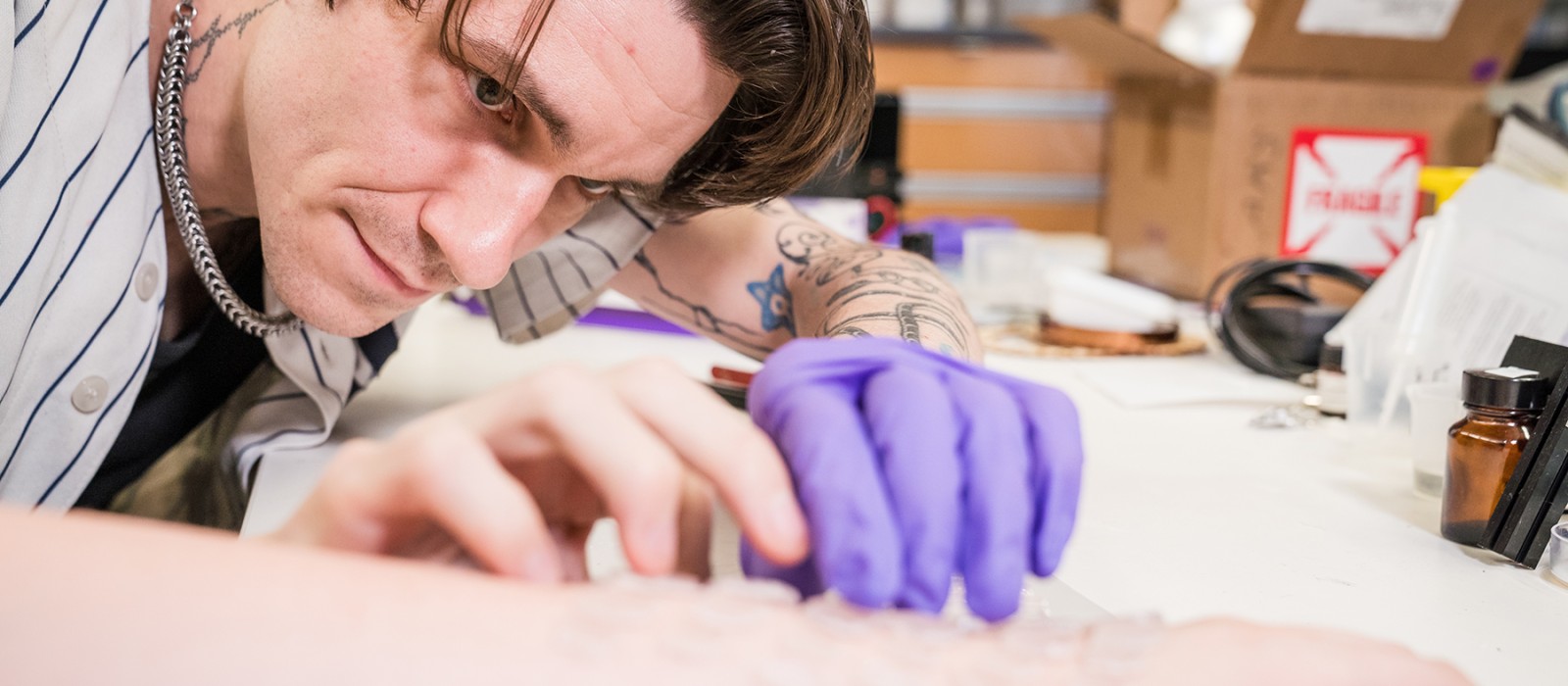 Artist applying 3-D tattoo 