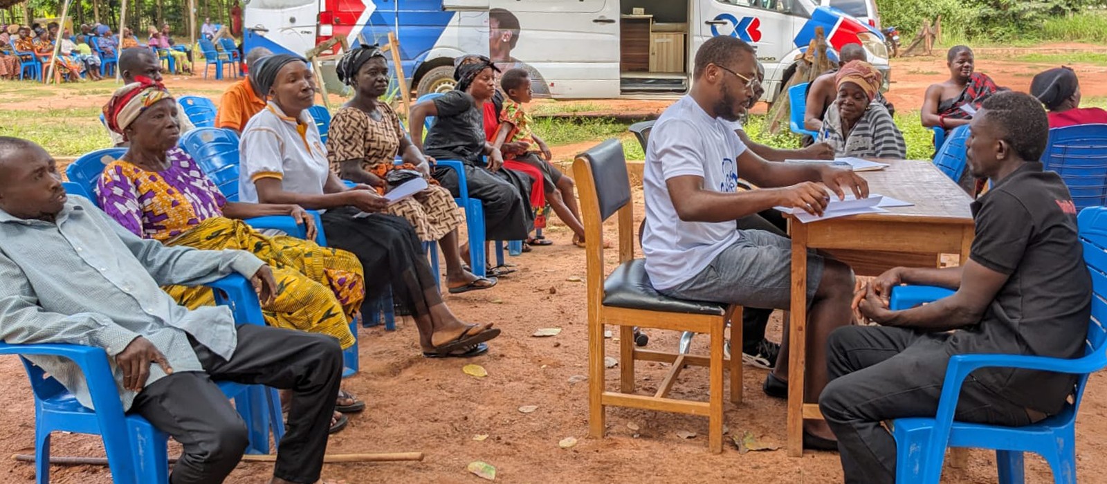Osei Boateng meets with patients in a community in Ghana