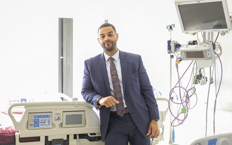 Man in a suit standing in a hospital room