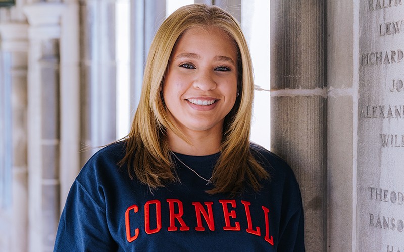 Thais Salas smiling and wearing a Cornell sweatshirt.