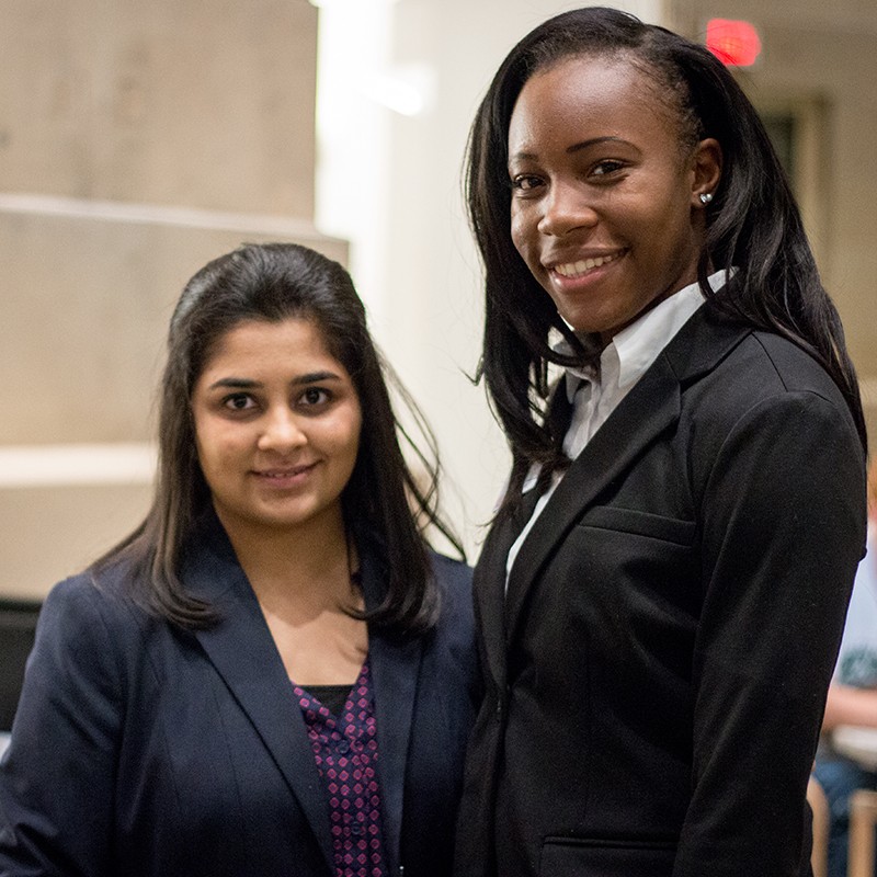 two sloan students at a welcome event