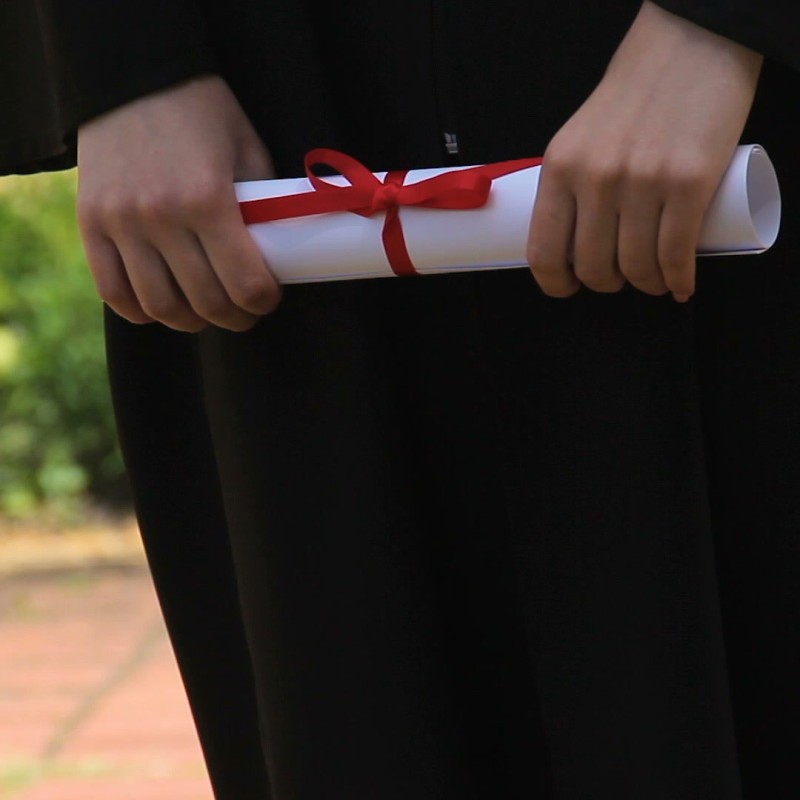student holding dipolma