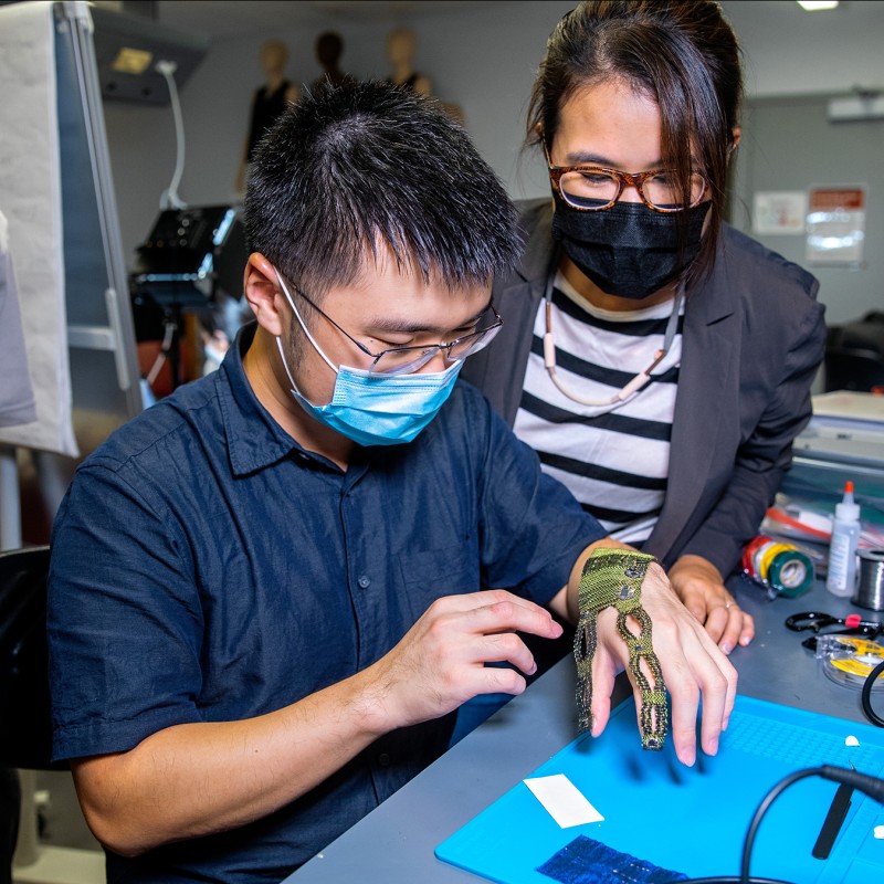 professor and students working on wearable tech