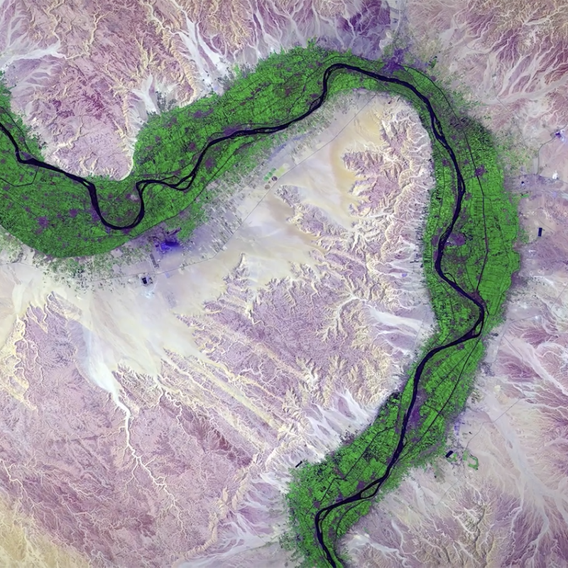 aerial view of a river and land colorized purple and green