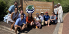 Students and Faculty standing in front of Parque Nacional Galapagos Ecuador sign