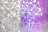 abstract web-like metal sculpture in silver and purple colors